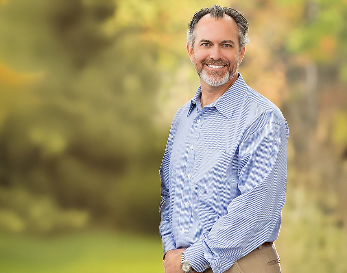 Michael-Riordan-DMD-blue-shirt-blurred-background